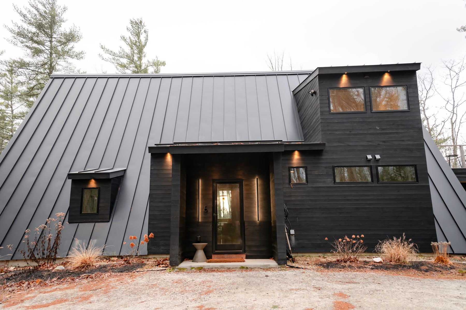 The Drover — dark clad barn-form shed home with a steep gable roof