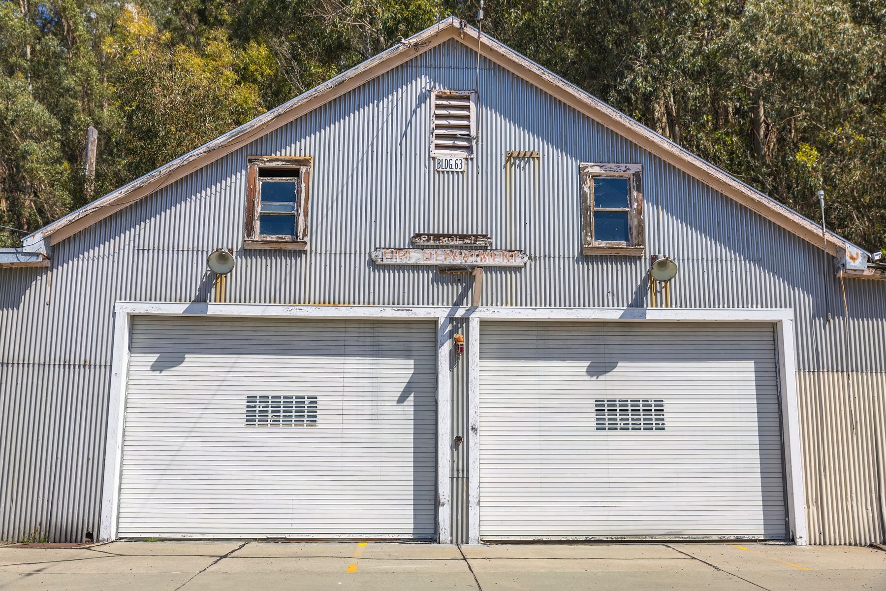 The Paddock — long shed home with four roller-door bays under one roofline